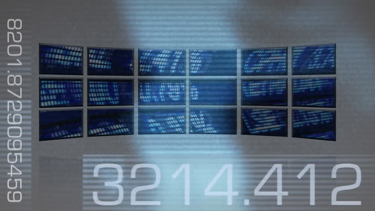 pantallas de computadora que proyectan datos del mercado de valores.