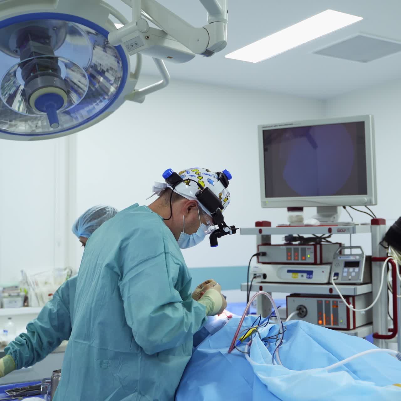 Experienced surgeon conducting otolaryngology operation. Doctor using metal tools and devices at surgery. Modern surgical room backdrop