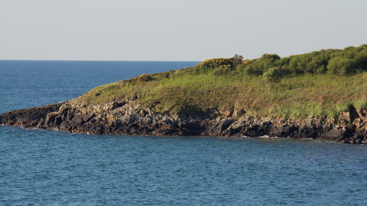 Mid shot Looking south on the rocky Shoreline at Hafan y Môr on Pen-y-chain, Pwllheli