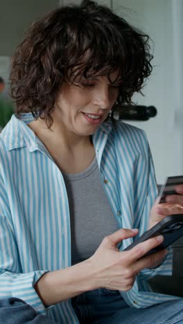 woman using phone and credit card