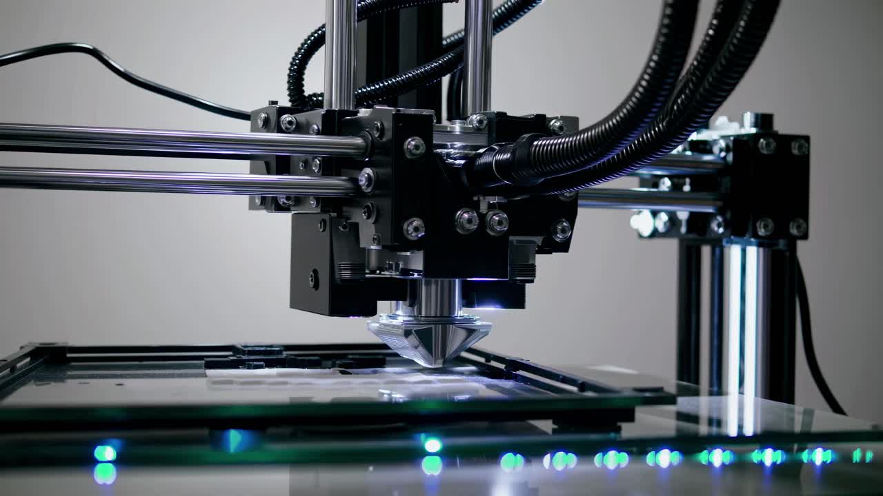 Close-up video shot of a 3D printer in action, showcasing intricate machinery and precision
