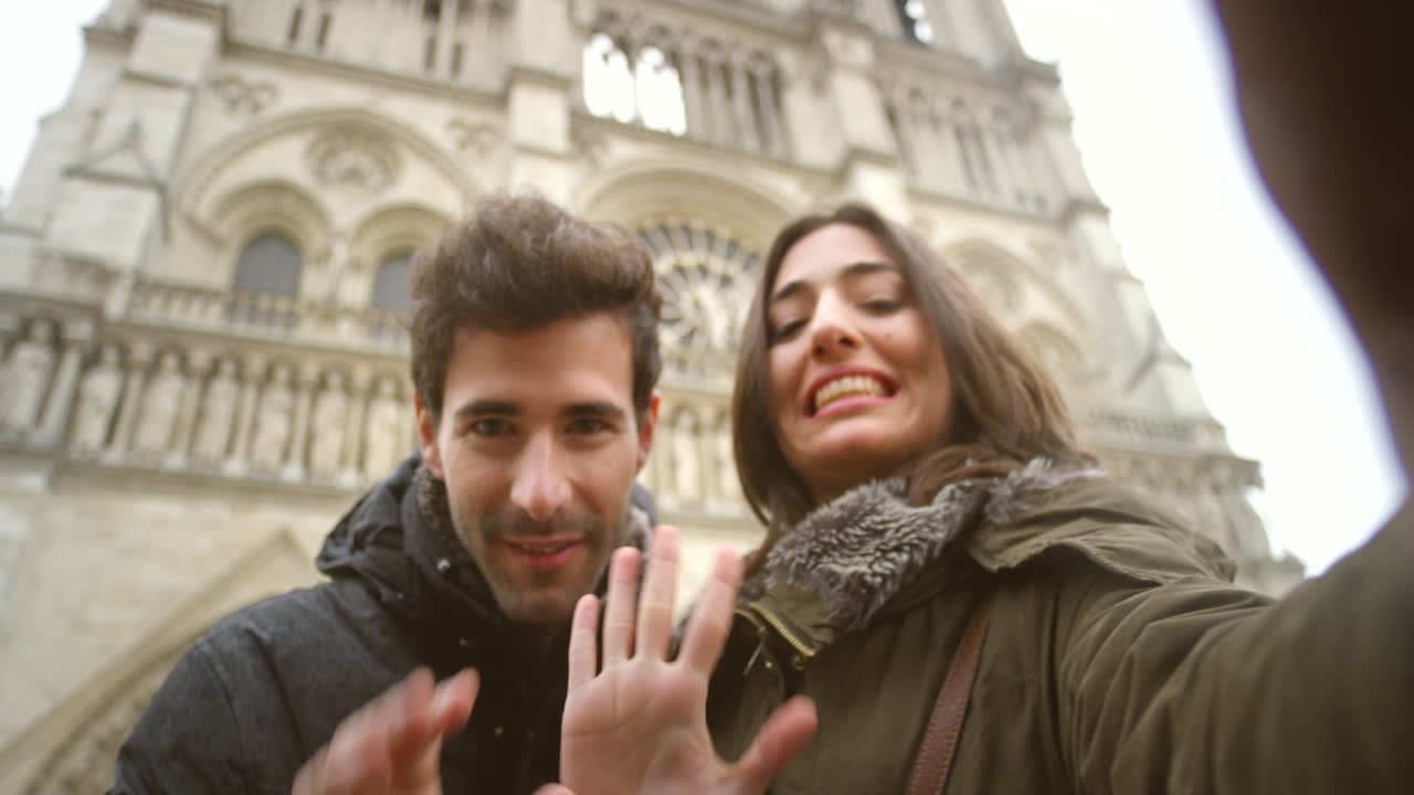 Happy young couple waving during a video call