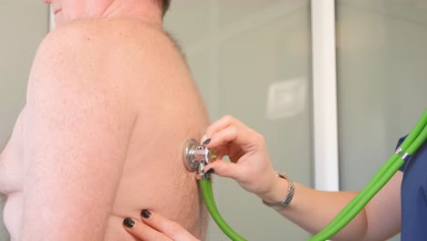a professional doctor listens to the work of the heart with the help of a stethoscope. medical examination in the clinic.