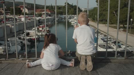 a beautiful view of the little girl and boy on the bridge