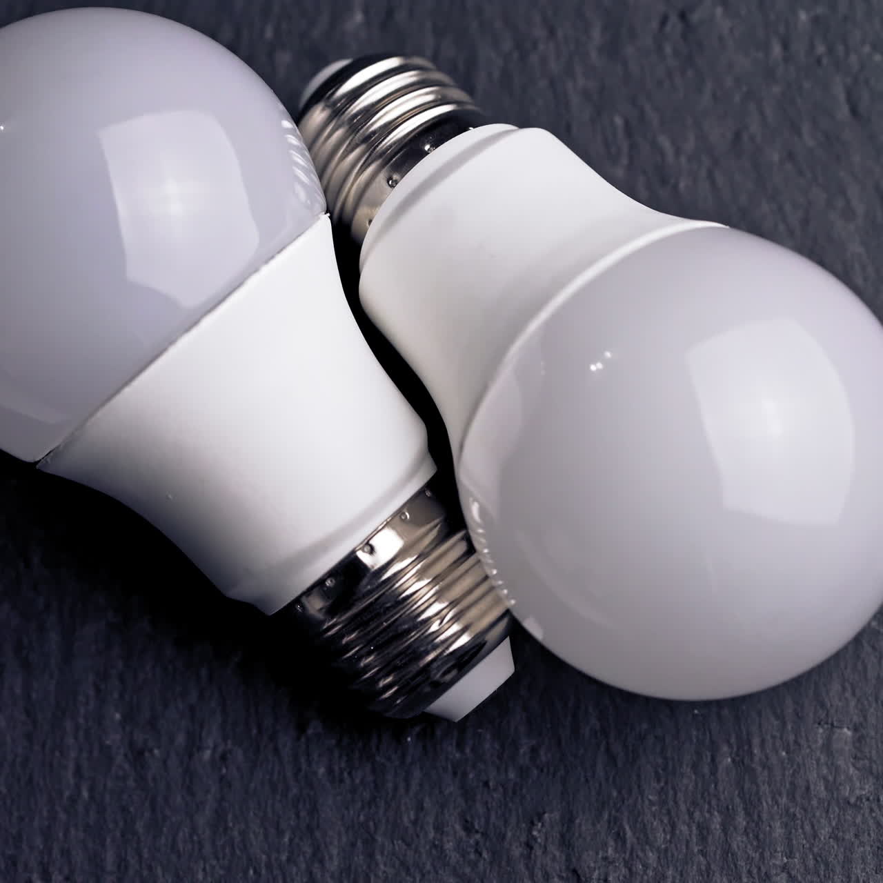 Energy saving light bulb on a black background.