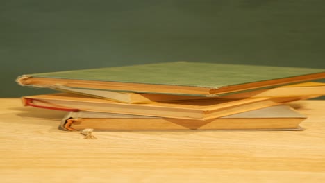 stack of old books on a wooden table