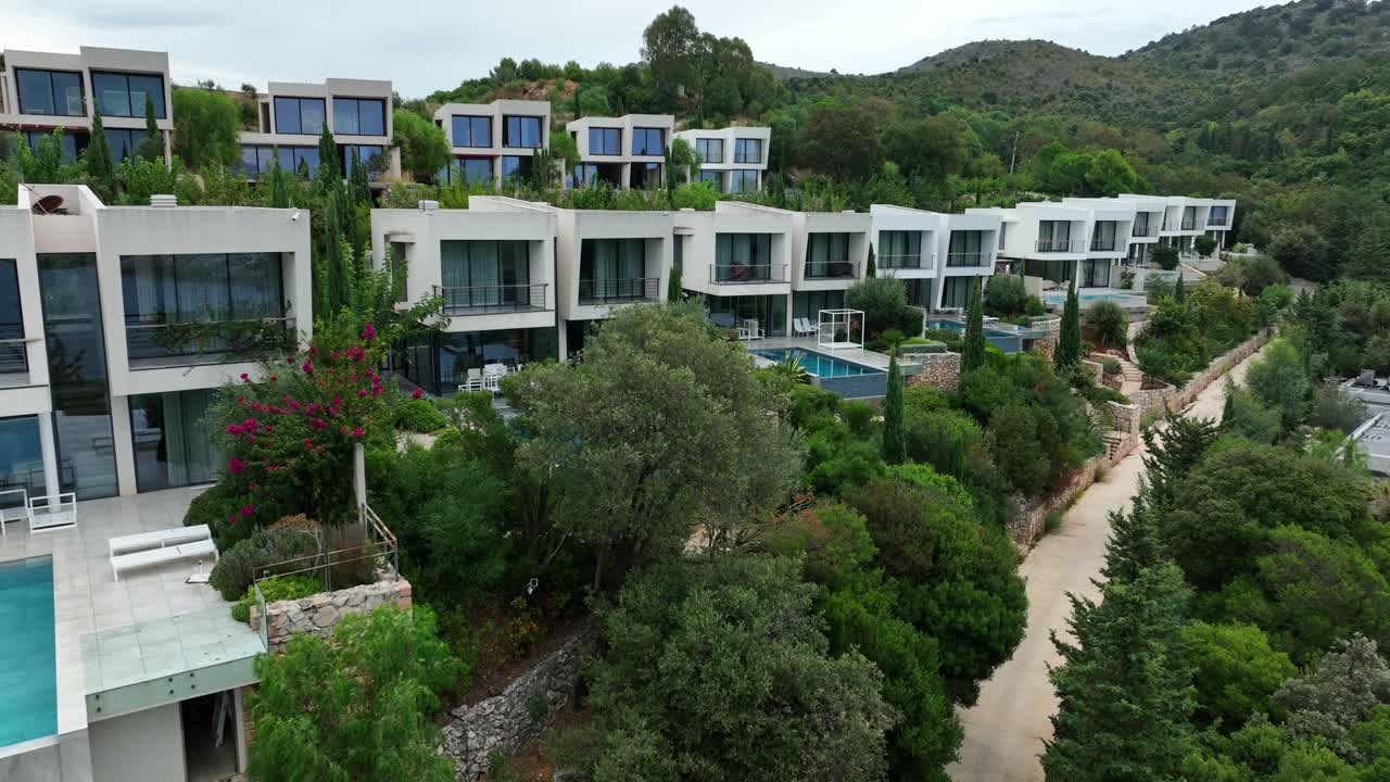 Charming houses with a pool nestled among green trees in Saranda, Albania, offering a peaceful retreat.
