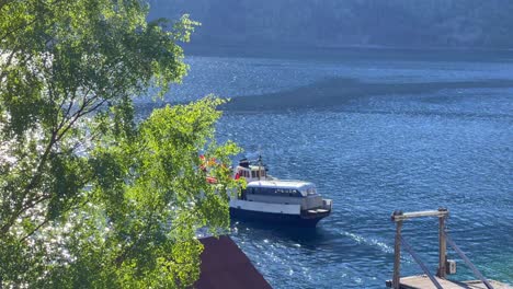 an old ferry departs from the quay in beautiful eikesdal in molde municipality