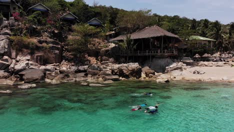 Kids-snorkeling-at-Aew-Leuk-Beach-at-Koh-Tao-in-Thailang,-filmed-with-Drone