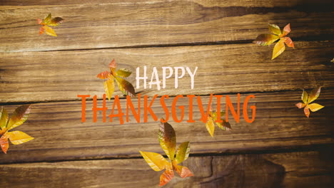animation of happy thanksgiving text over autumn leaves on wooden boards