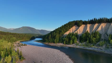 flying over peaceful nature of forest and mountains in flathead river, montana usa