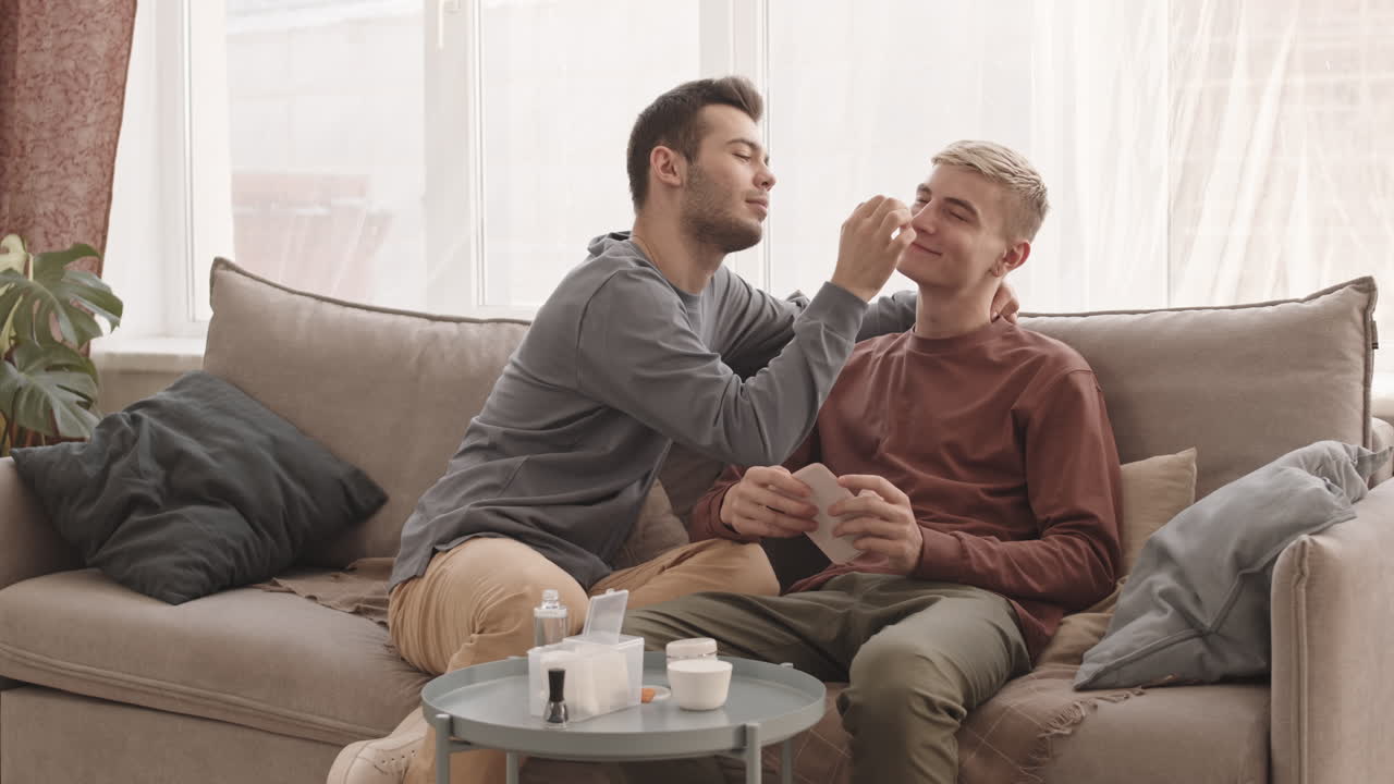 Young Man Taking Care of His Boyfriend Facial Skin