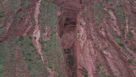 Rock-formation-due-to-erosion-in-reddish-stone,-Devil's-Throat,-geological-tourism-area-in-Salta,-Argentina