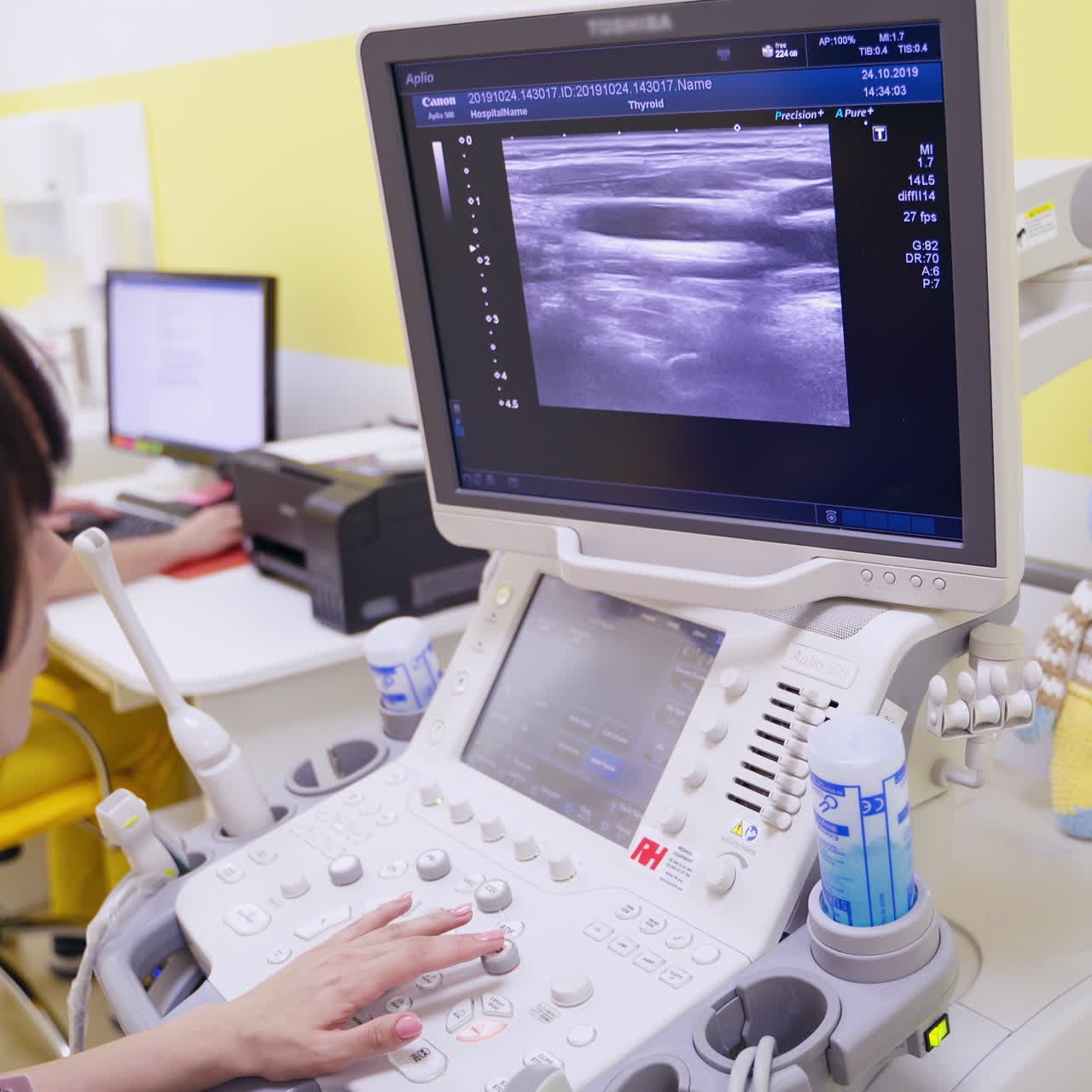 Woman doctor working with modern equipment in clinic. Specialist looking at the screen of monitor during ultrasound diagnostic.
