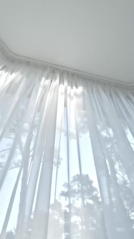 sheer white curtains with natural light filtering into modern room, vertical
