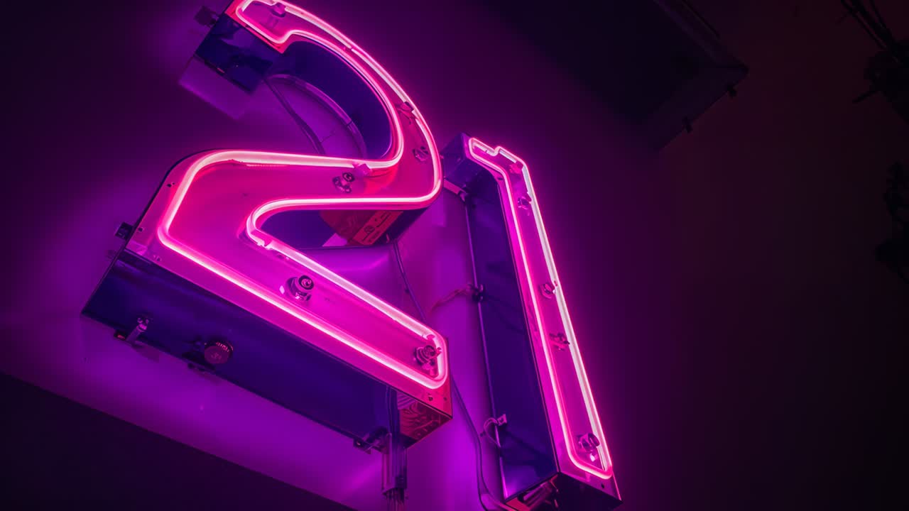 Power dip causing magenta neon tubing pulsing at shopfront, with mounting boxes, clamps, conduit