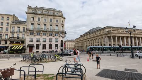 tram moves through bustling bordeaux city square