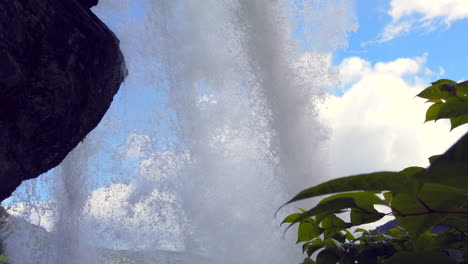 Fantastic-Steinsdalsfossen-Waterfall-in-Steine,-Norway-tilt-up-with-framing-from-behind-falls-BEST-4k-ProRezHQ