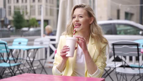 woman enjoying a drink in a cafe