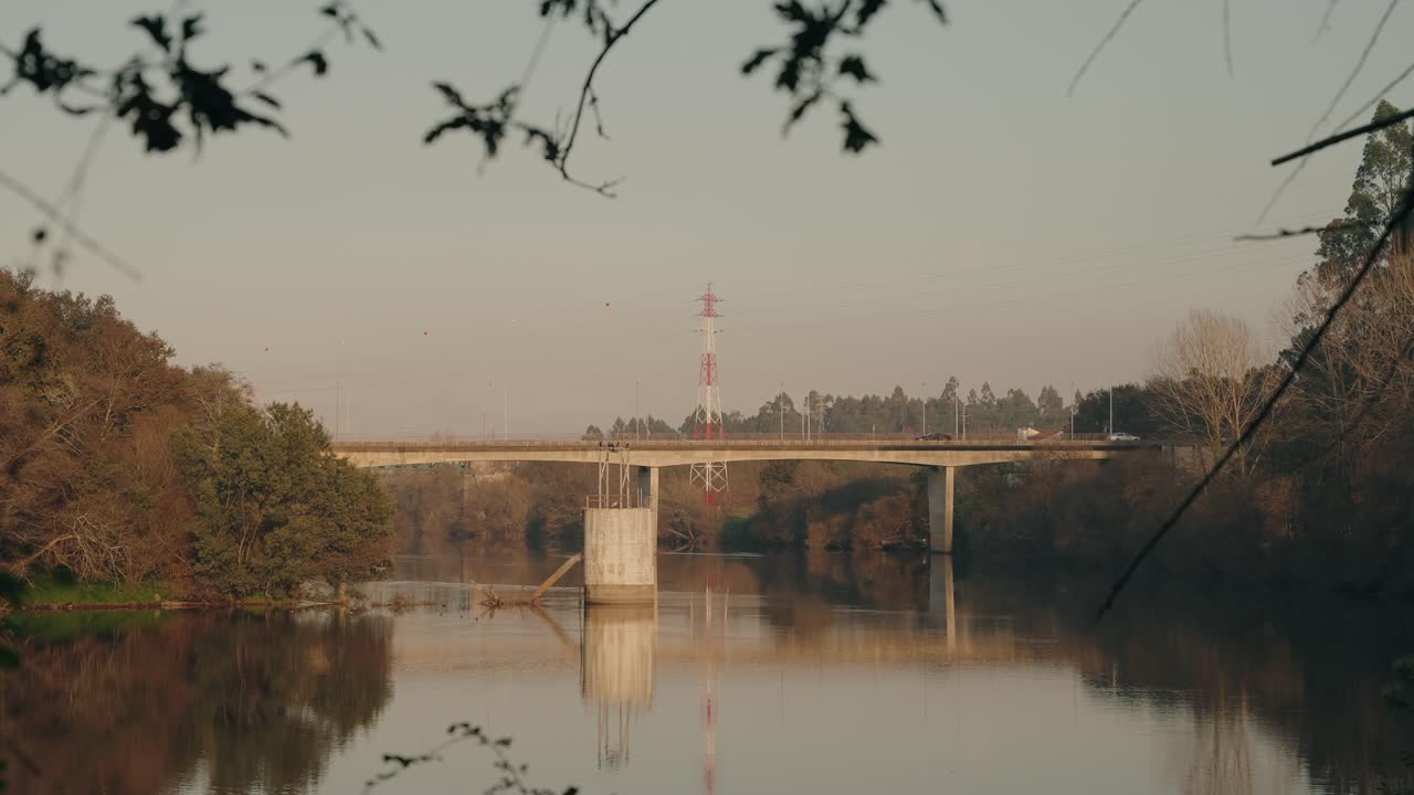 still bridge crossing river with tranquil reflections at dusk