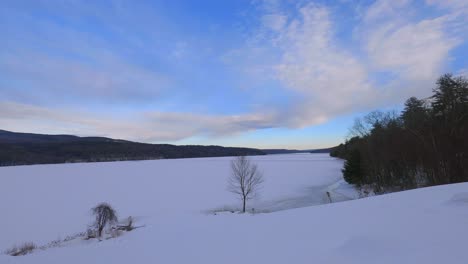 cloud time lapse over a frozen, snowy mountain lake in the appalachian mountains in america in new york in the hudson valley in the catskill mountains during winter