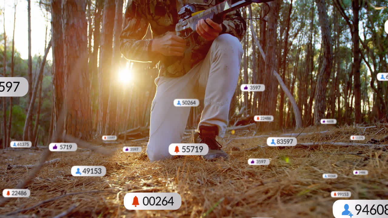 Man kneeling in pine forest gripping rifle, with notification icons floating showing technology