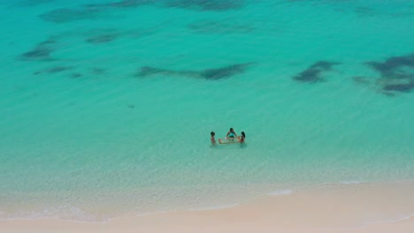 Blick-Von-Oben-Auf-Drei-Weibliche-Touristen,-Die-Das-Türkisfarbene-Meer-Von-Pedernales-Genießen