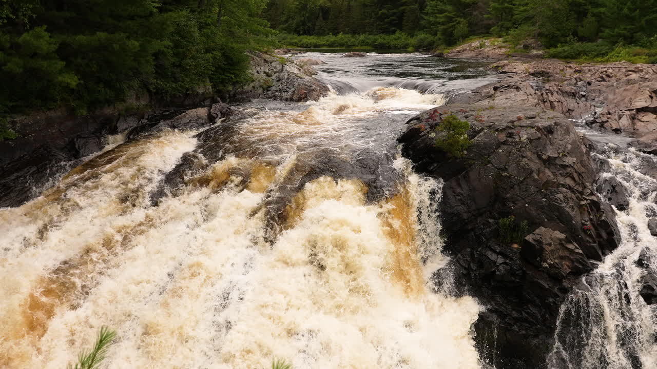 Water cascading down a picturesque waterfall in slow motion