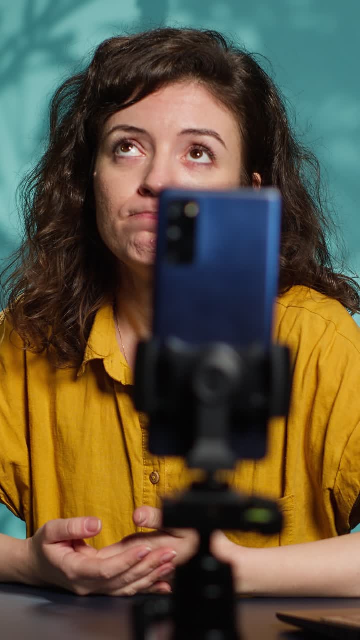 Emotional Woman Recording Video Message on Smartphone