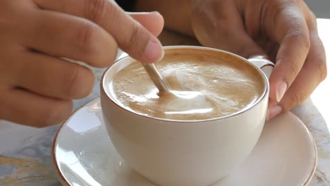 close-up of a cup of coffee with latte art