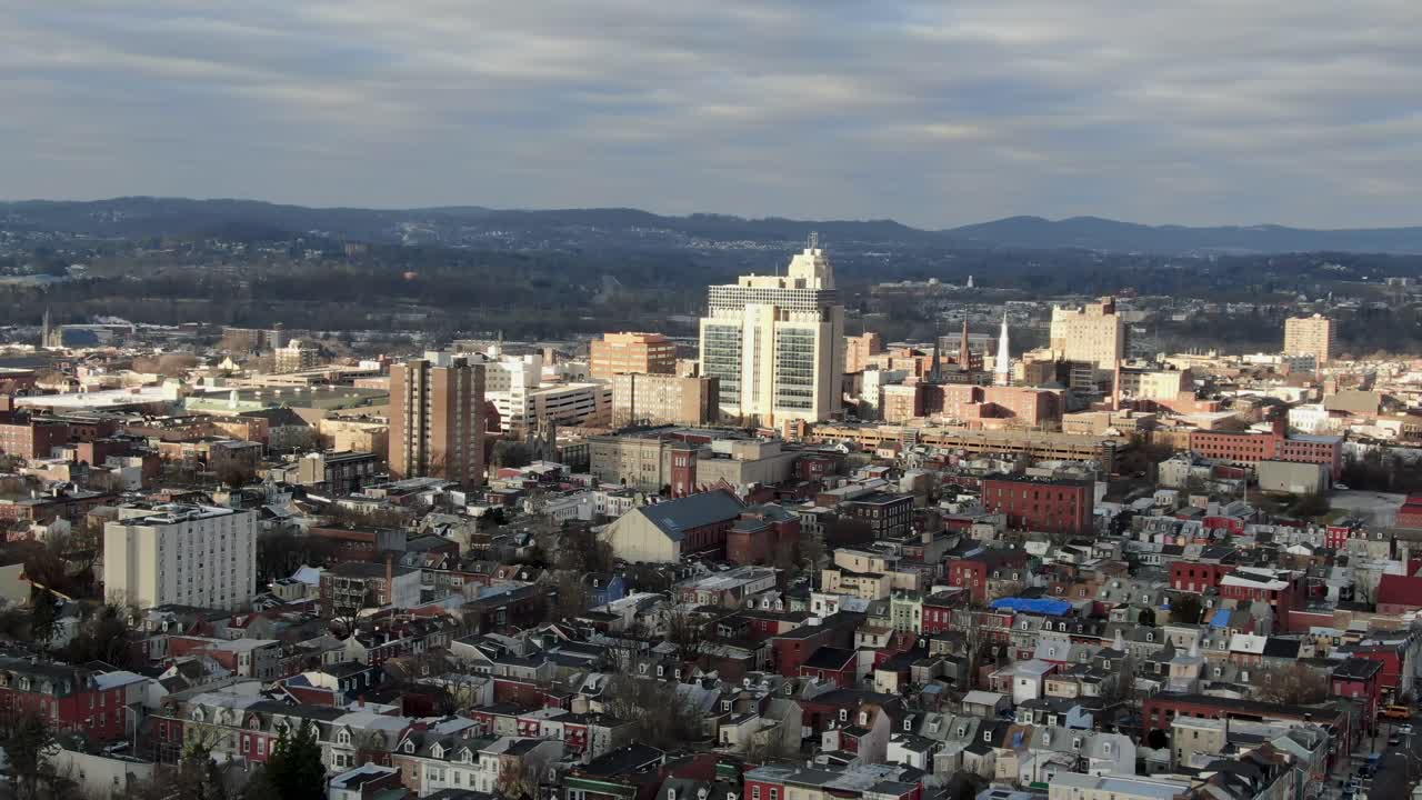 Establishing shot of urban city in USA, residential district and downtown business zone visible in dramatic sunlight
