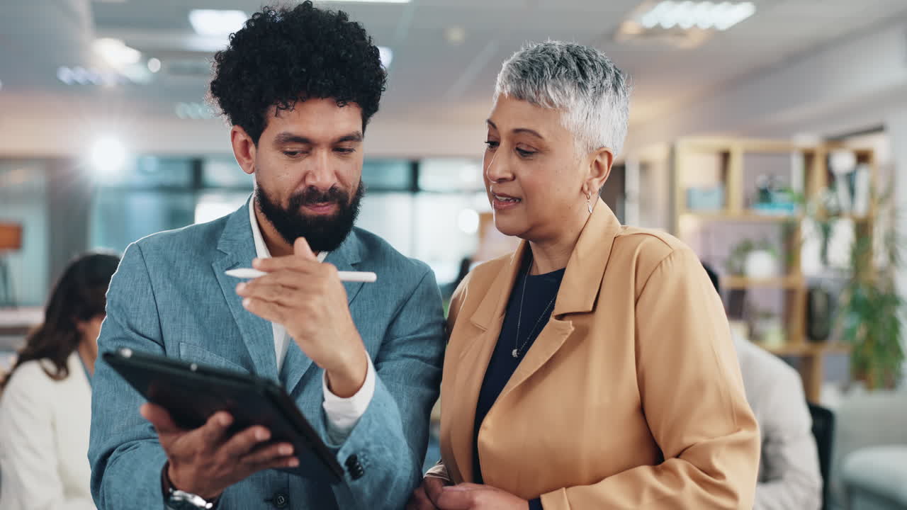 Two businesspeople working together in an office setting
