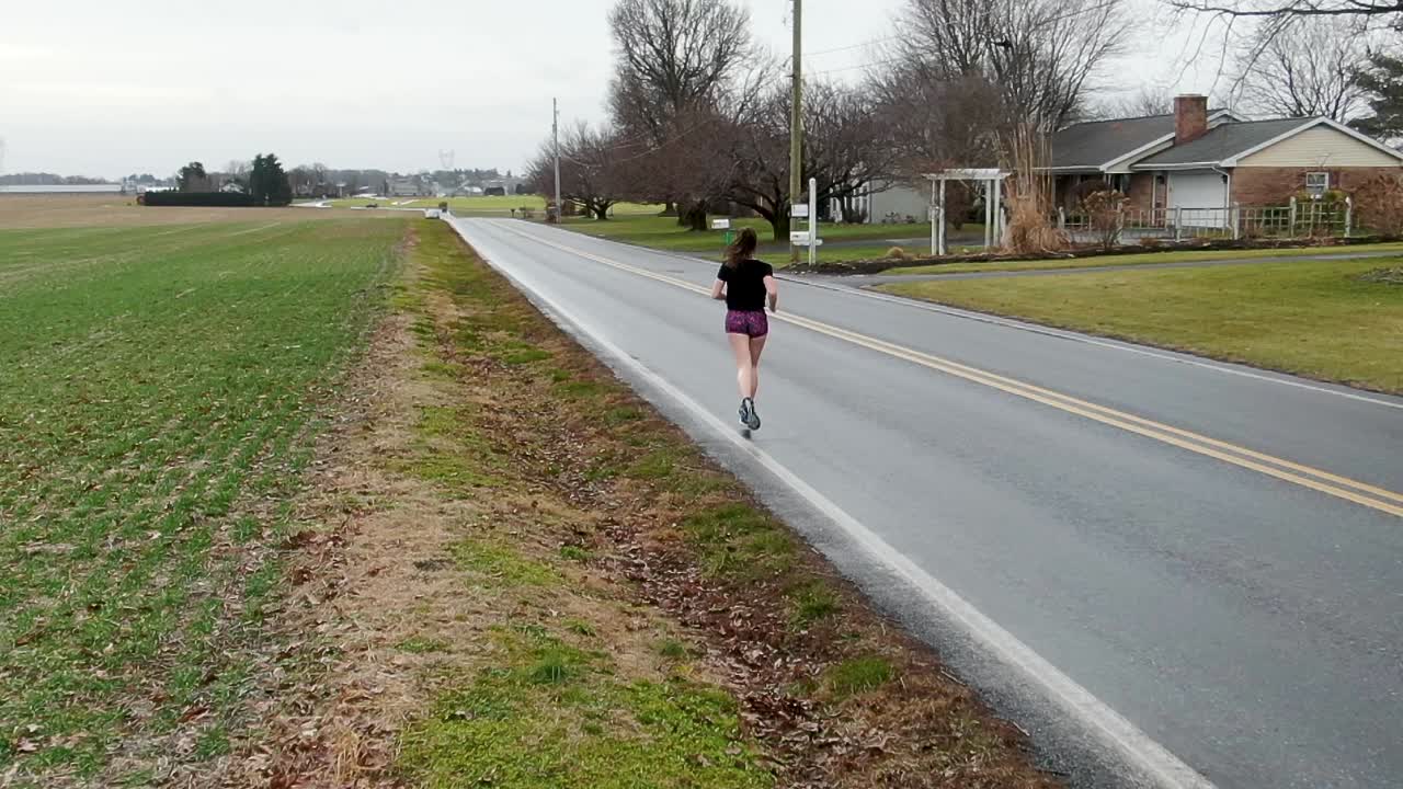 Cardio workout, grit and determination of a young woman running, exercise, training, mental health theme, freedom in USA