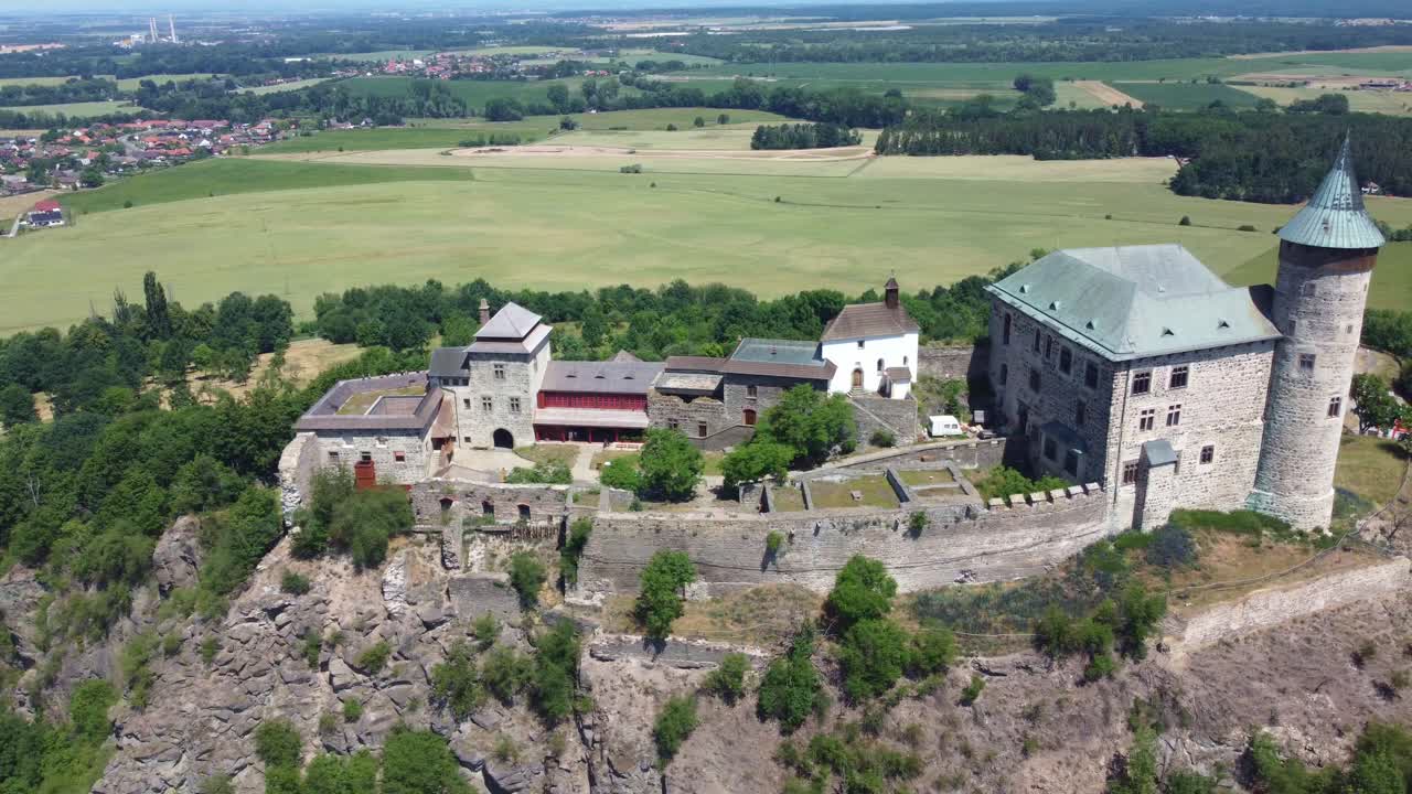 Flyover aerial tracking right of Kuneticka Hora Castle in Czech Republic with tower and vast green surroundings