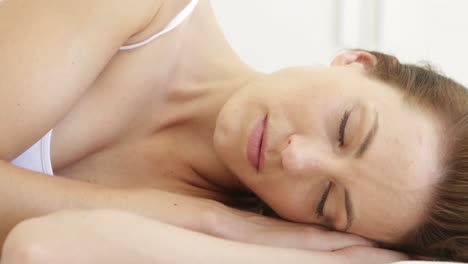 Beautiful-brunette-sleeping-on-her-bed