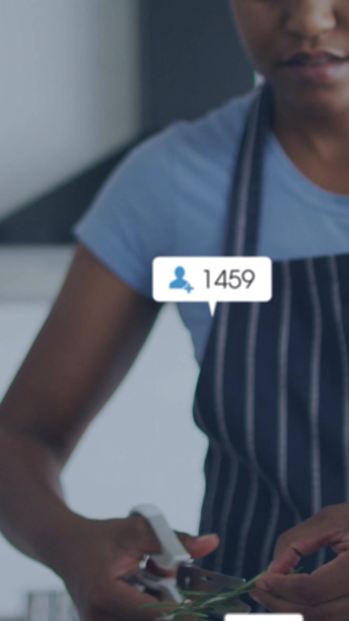 Vertical video: Woman starting snips with shears for cooking, magnifier or follower icons over hands