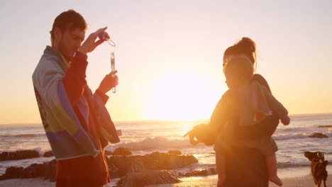 Family-having-fun-in-the-beach-4k