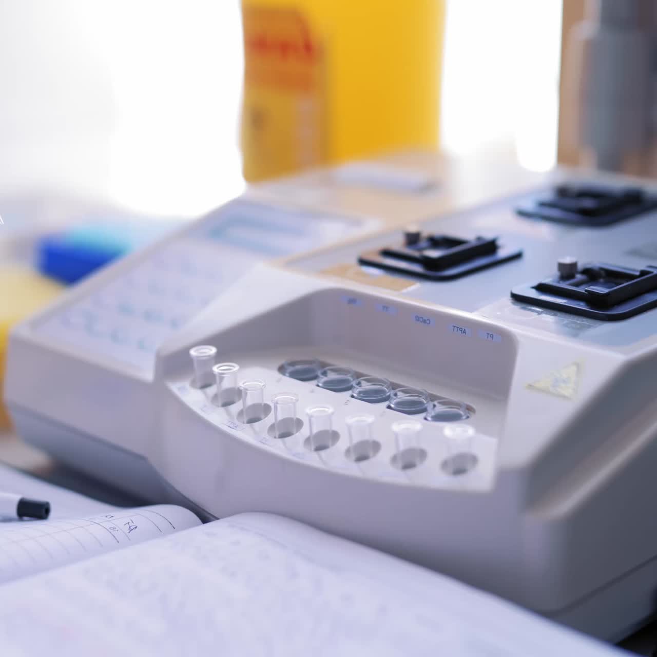 Technicians operating machine in laboratory