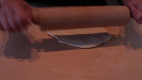 woman kneading dough in flour and making italian tigelle using a tool