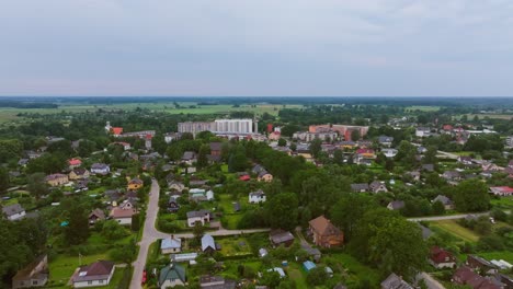 establishing drone footage showing iecava’s rooftops and overcast scenery