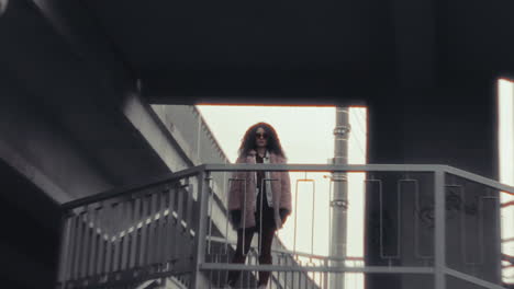 Young Confident Woman Standing on Elevated Walkway of Urban Overpass