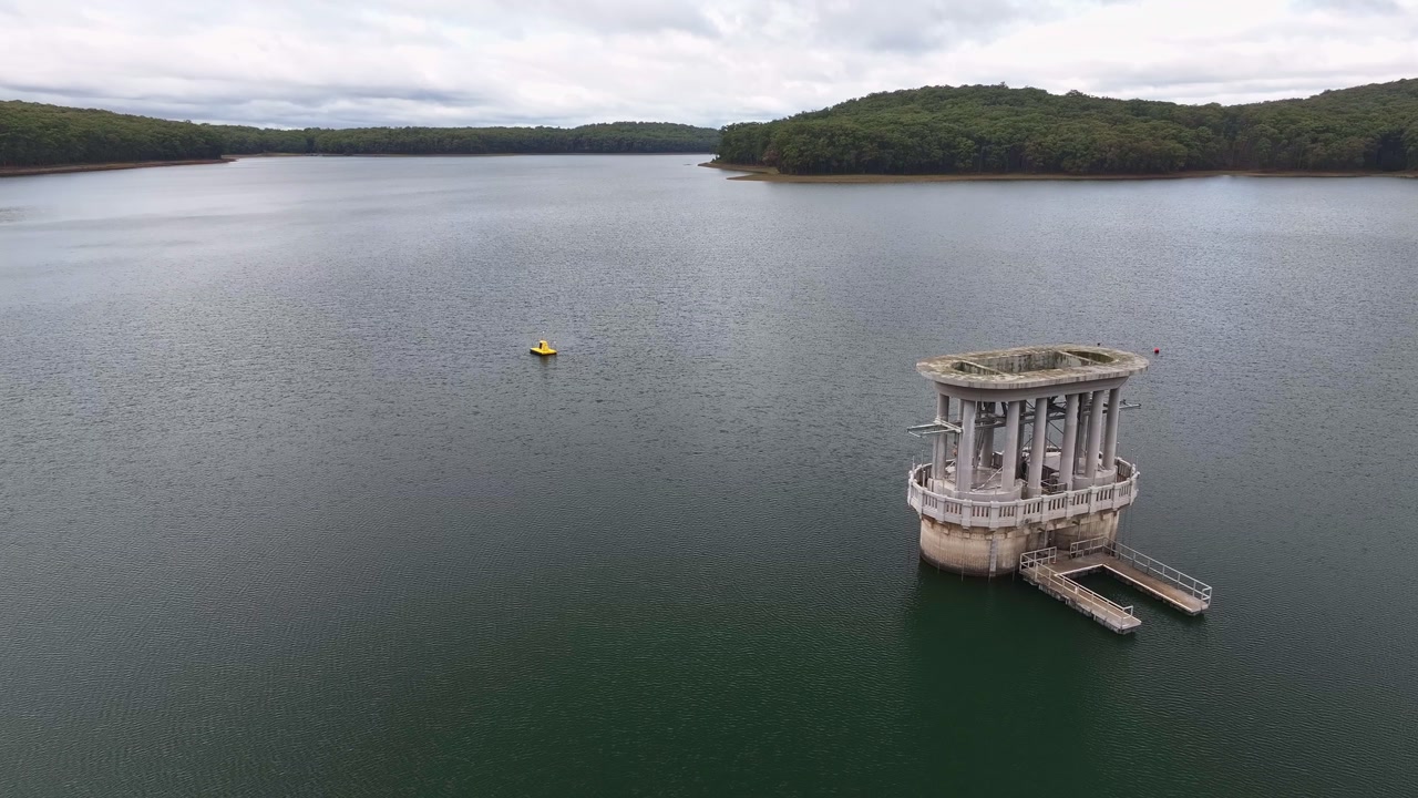 Close view of Silvan Reservoir intake tower showing structural detail and forest surrounds