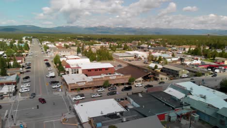 pan view over west yellowstone city center with avenue and mountains on horizon, montana, usa