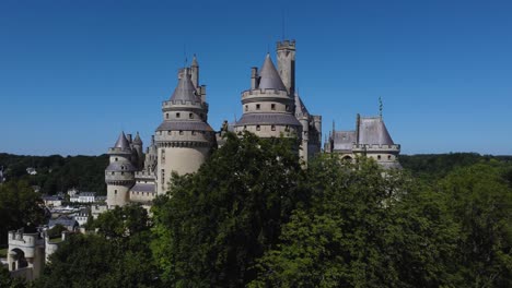 revealing pierrefonds castle, france over trees
