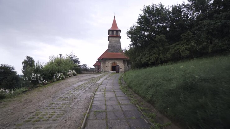 Old gray church located on top of the hill in the forest, rainy day