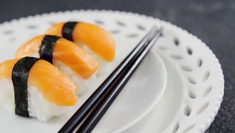 sushi served on plate with chopsticks