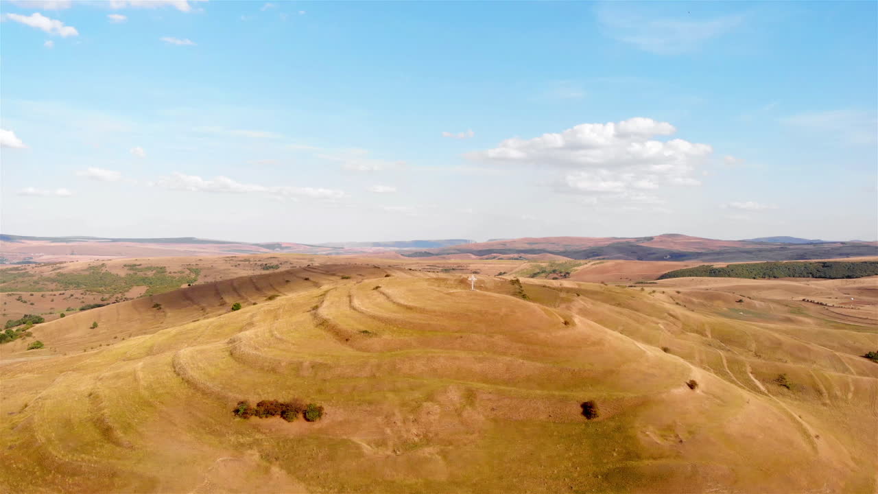 Aerial footage over Large Cross on top of High Hill and landscape at Summer