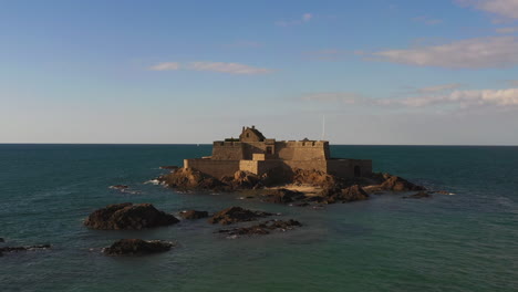 an aerial shot of an old fortress built right off the coast of st