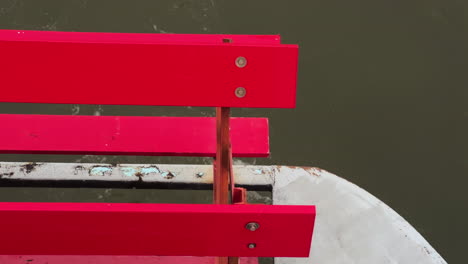 Slow-Motion-Of-Rotating-Red-Paddle-Wheel-Of-A-Cruise-Boat-Over-Ohio-River-In-Cincinnati,-USA