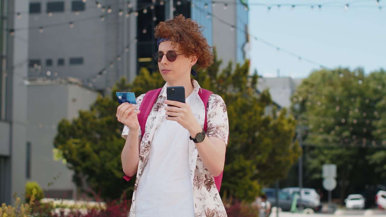 Tourist man using credit bank card smartphone while transferring money purchases online shopping